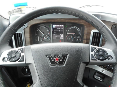 Western Star 47X steering wheel and dashboard visible with center digital display, woodgrain trim, and various gauge clusters.