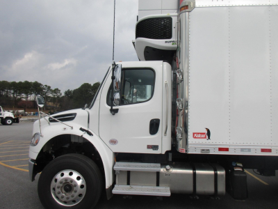 Freightliner M2 106 Plus cab in profile with refrigerated box, showing front fender, step, fuel tank, and Kool-guard style refrigeration unit at top of cargo area.