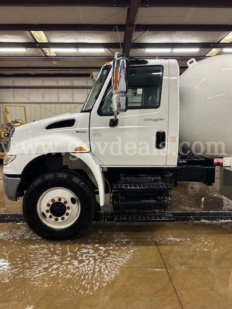 Truck side view of 2011 International 4300 with a large cylindrical tank, stock number 12194-13, used status.