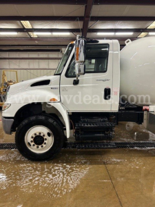 Truck side view of 2011 International 4300 with a large cylindrical tank, stock number 12194-13, used status.
