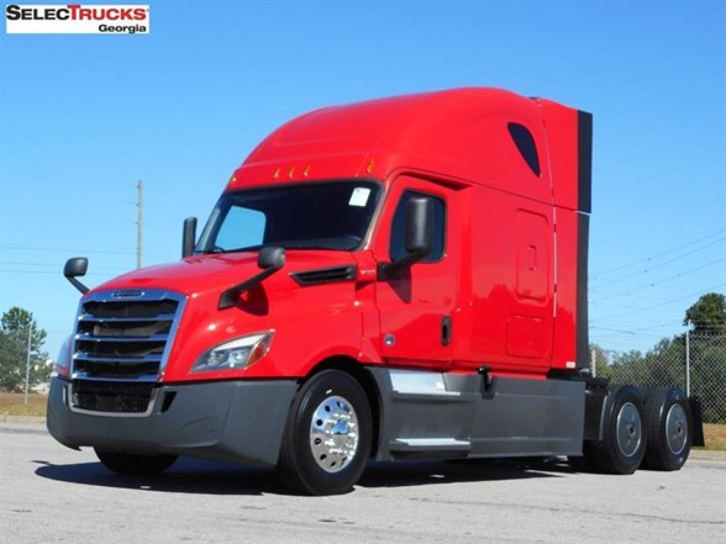 Freightliner Cascadia 126 sleeper cab tractor in red, side view showing front grille, windshield, mirrors, and dual rear axles.