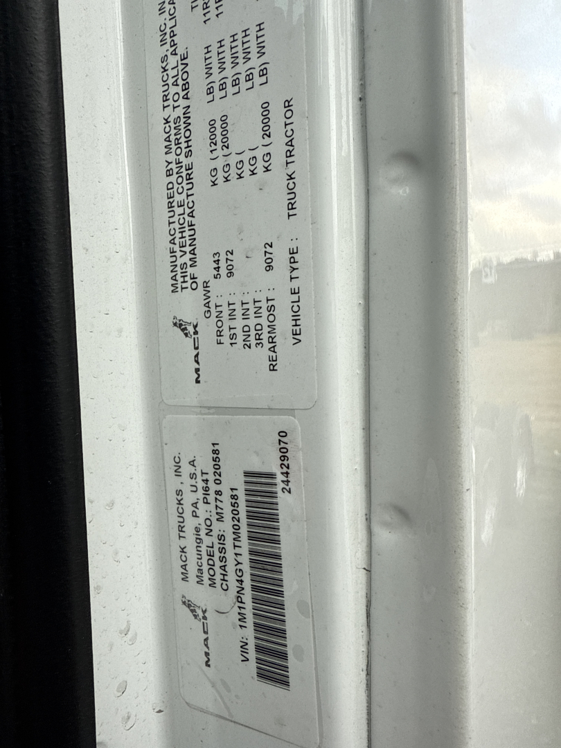 Truck VIN sticker showing manufacturer details and weight specs for a Mack truck. Visible text includes VIN, stock number, manufacturer, and labels like GVWR, GAWR, rear axle weights, and vehicle type.