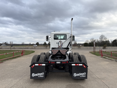 Truck chassis rear view showing dual rear axles and mudflaps with Bruckner's Equipment branding.
