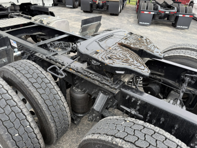 Truck chassis and fifth wheel area of a 2027 Mack AN64T with dual rear axles and fifth wheel kingpin visible.