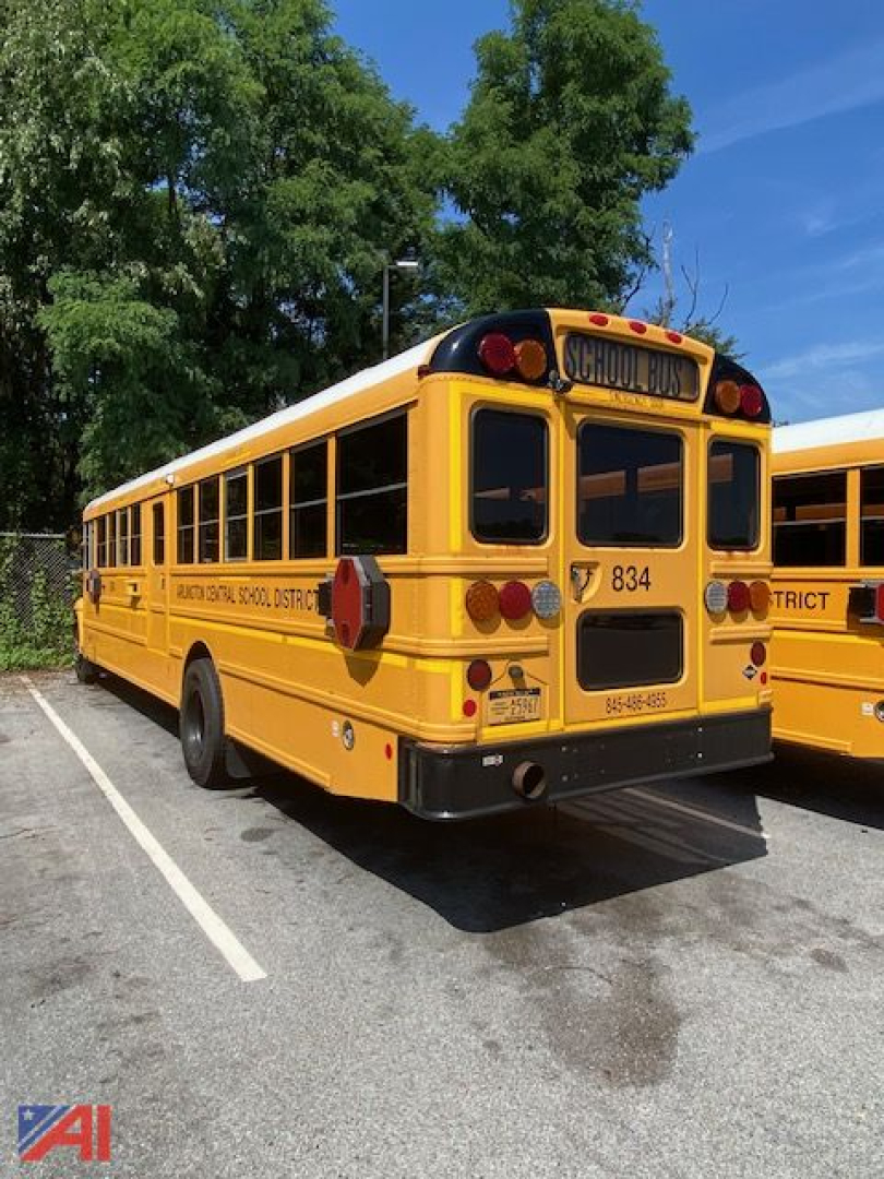 School bus rear view showing yellow International 3000 bus with bus numbers 834 and district markings visible.
