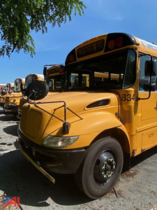 School bus front-left view showing yellow 2018 International 3000 school bus with hood, mirrors, and bus number 834.