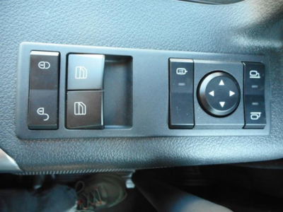 Dashboard control panel on Western Star 47x showing window/mirror switch cluster and circular navigation button.