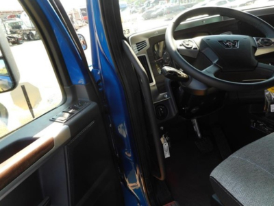 Western Star 47x truck interior view showing steering wheel and dashboard, blue exterior visible at door.