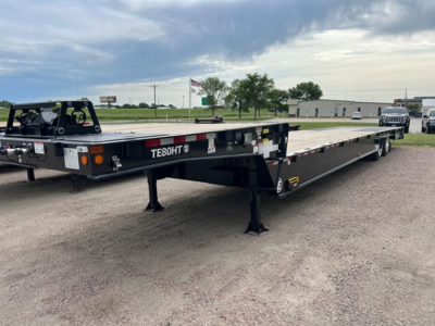 Trailers showing a flatbed trailer with TEBOHT branding and a low-profile landing gear; visible text includes TE60HT? and light fixtures at rear.