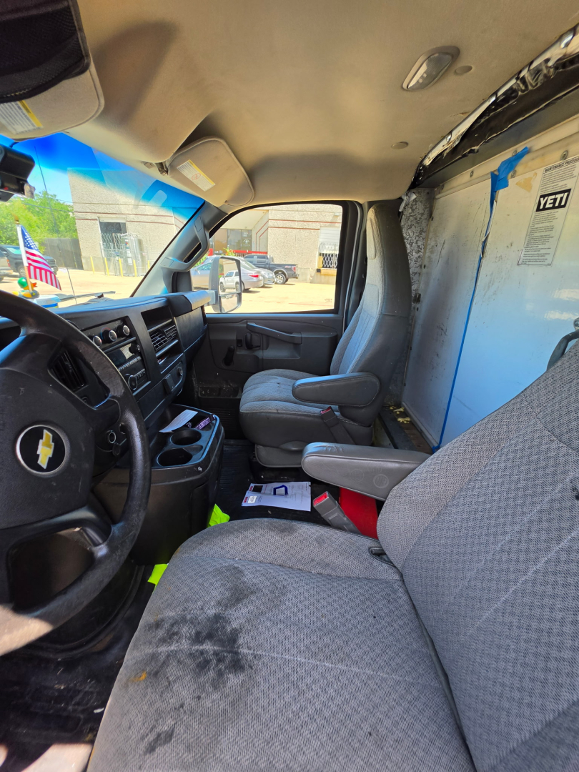 Chevrolet Express 3500 van interior showing front cabin and passenger seat with dashboard and steering wheel.