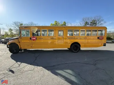 School bus side view showing Stop sign, LESKILI? IMONDVILLE CENTRAL SCHOOL markings, yellow body.