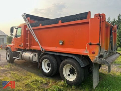 Volvo dump truck side view showing orange truck bed and dual rear wheels