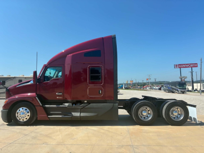 Kenworth T680 conventional sleeper truck side view showing red cab and dual rear axles.