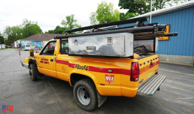 GMC Sierra SL Dually emergency pickup truck with yellow body and utility equipment in bed, 4x4, emergency decals and equipment rack.