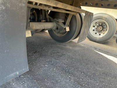 Rear view of Hyundai air ride dry van trailer showing suspension components and wheel wells undercarriage.