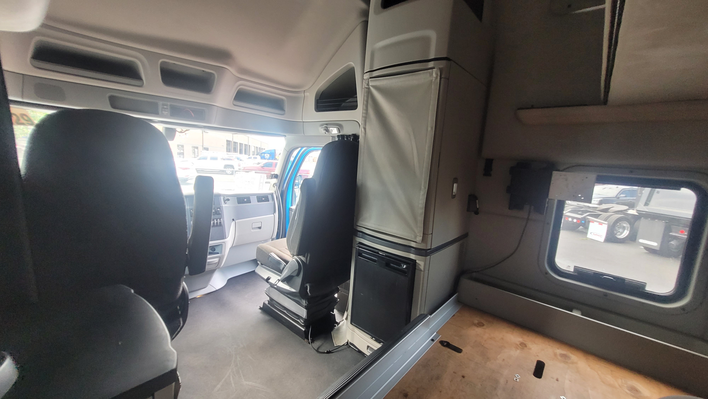 Peterbilt 579 cab interior showing sleeper area and cab wall with storage cabinets.