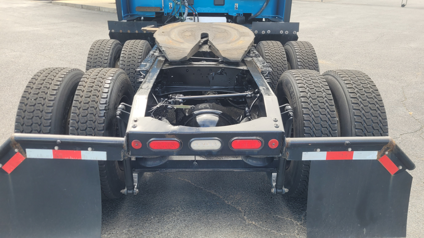 Peterbilt 579 truck rear view showing fifth wheel and dual rear axles with dual tires and chassis components.