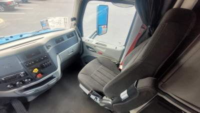 Peterbilt 579 cab interior showing steering wheel, dashboard, and driver seat in a sleeper truck.