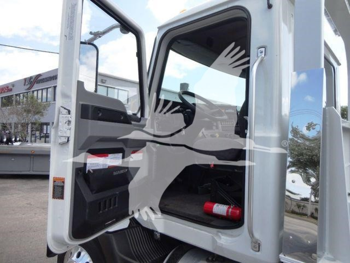 Cab interior of a 2026 Mack MD6 truck with door open and dashboard visible.