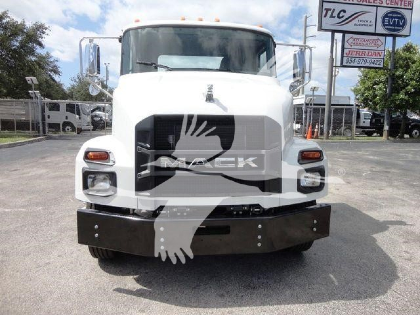 Front view of a white 2026 Mack MD6 rollback truck showing grille, bumper, and headlights.