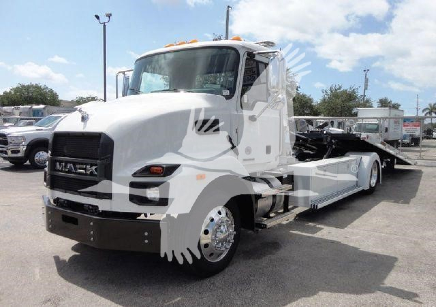 2026 Mack MD6 rollback tow truck with white cab and flatbed, front grille reads MACK, stock number J04370 in lot.