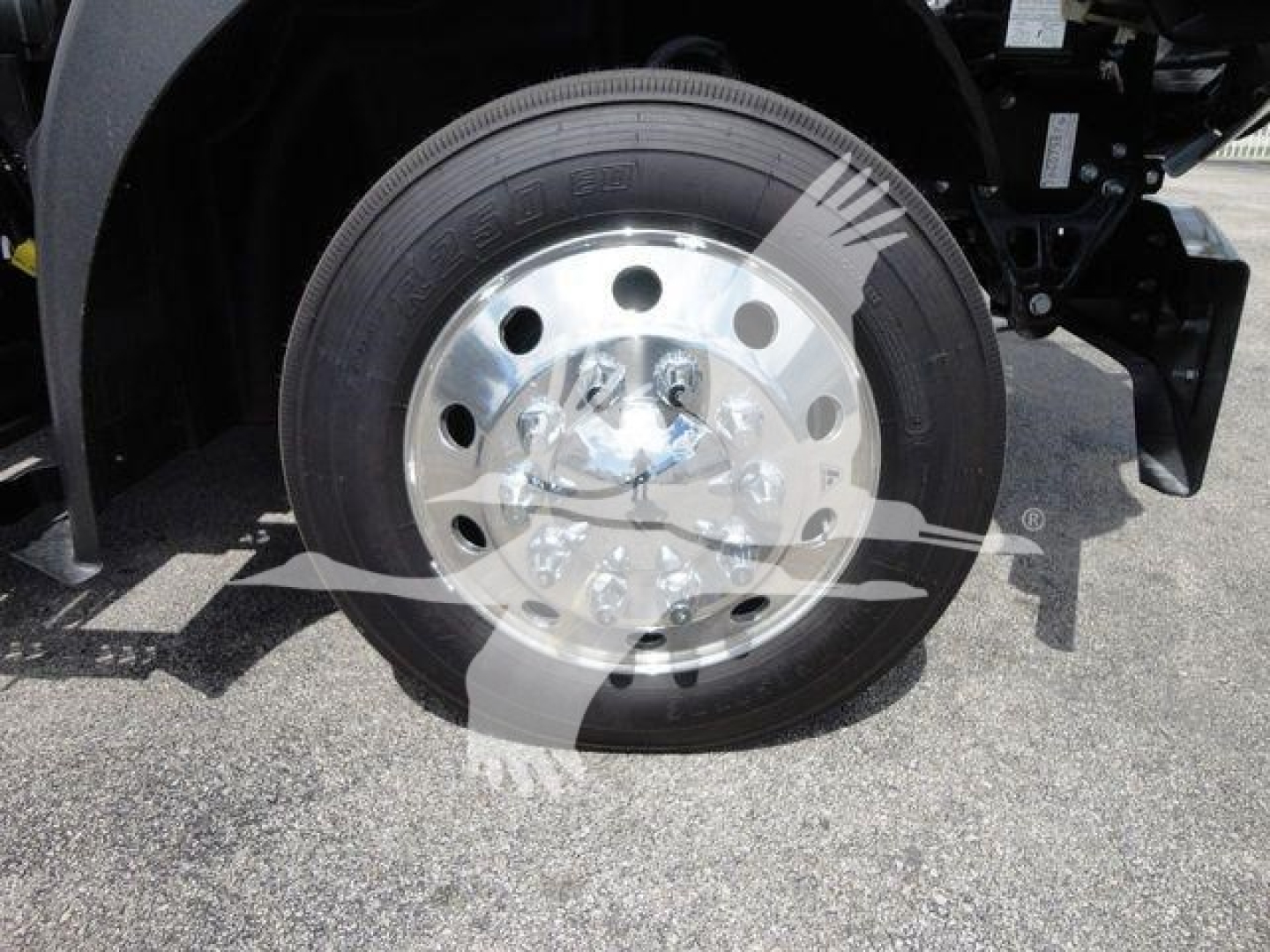 Mack MD6 truck wheel and hub showing front tire and polished steel rim in-vehicle view