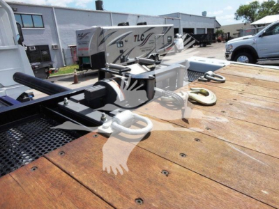 MD/MD6 Mack truck rollback equipment on flatbed with winch and hitch components visible.