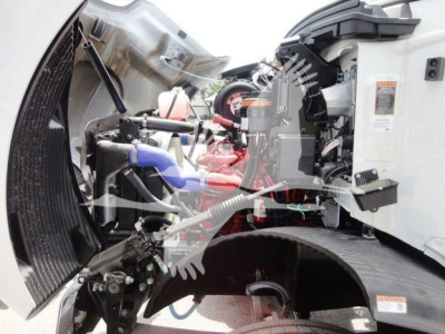 Mack MD6 engine bay showing diesel engine with red components, blue hoses, exposed wiring, and diagram label on the side panel.