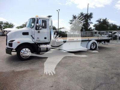 MD6 Mack rollback truck in profile showing flatbed and wheelbase, stock number J04370, new unit, white cab and flatbed with side rails.