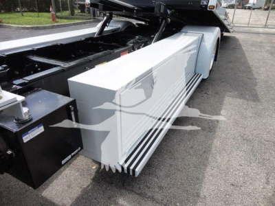 Mack MD6 rollback truck chassis showing side storage box and dual rear wheels.