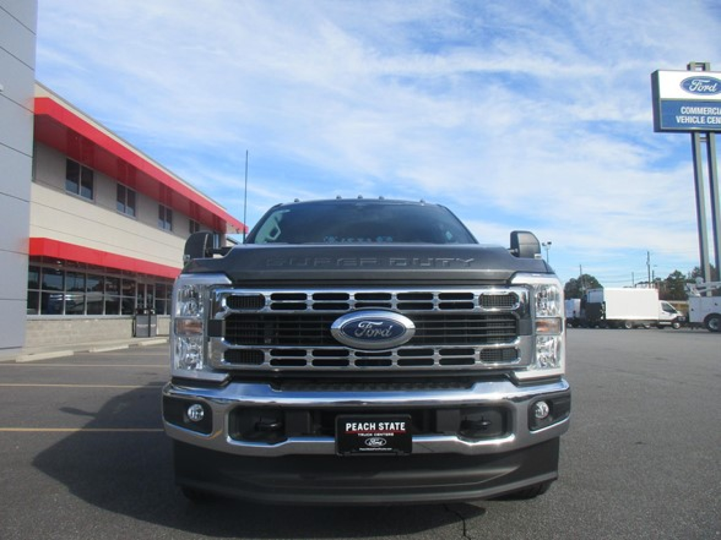 Ford F-350 truck front view showing grille, headlights, and bumper with Ford emblem; dealership plate frame visible.
