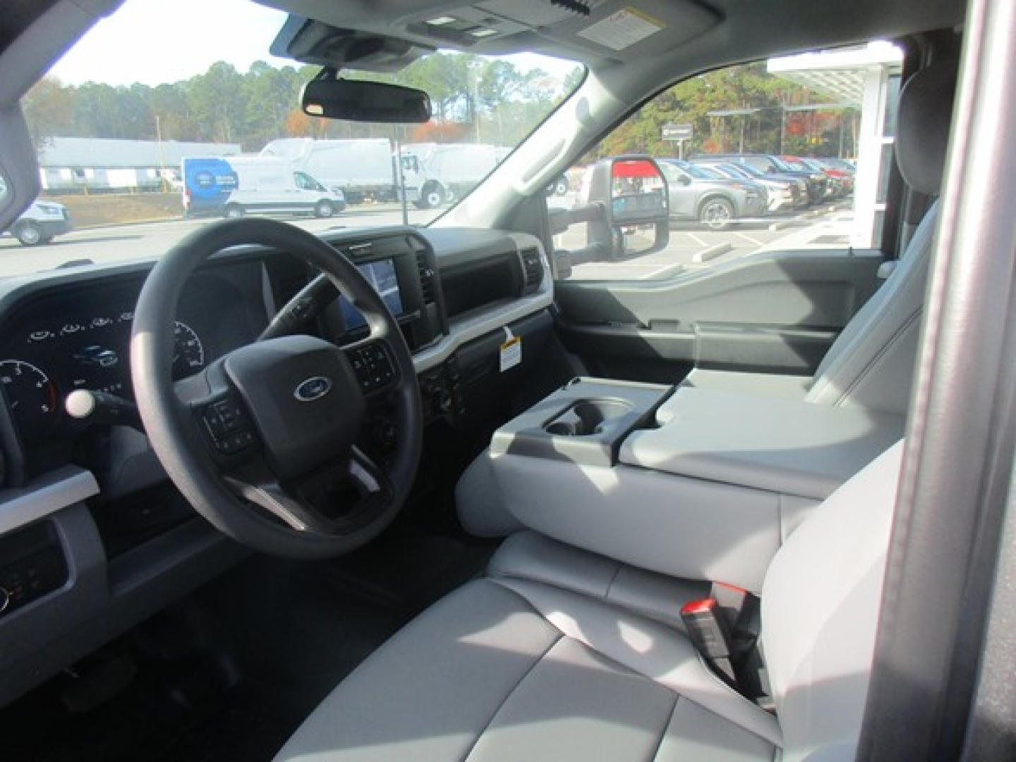 Interior of a 2026 Ford F-350 SD crew cab showing steering wheel, center console, and front seats.