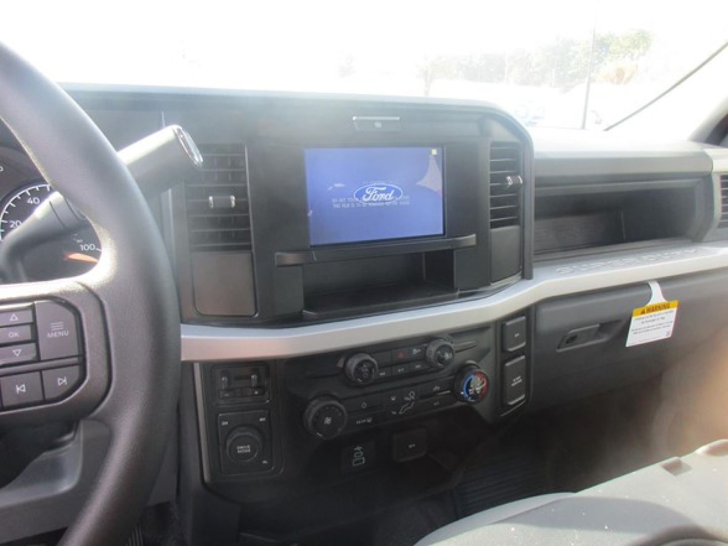 Ford F-350 Sd truck interior showing dashboard with Ford infotainment screen and center console controls.