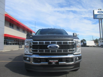 Ford F-350 truck front view showing grille, headlights, and bumper with Ford emblem; dealership plate frame visible.