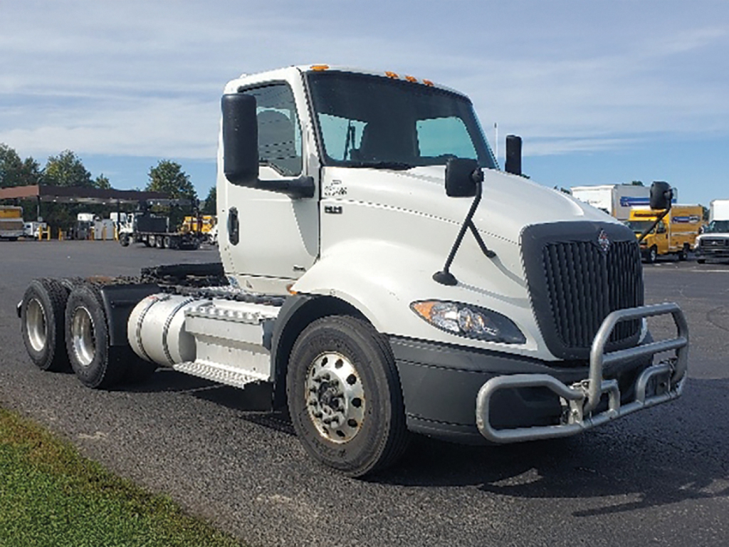 International RH613 conventional daycab truck side view showing cab, fuel tanks, and bumper guard with wheel wells and dual rear axles
