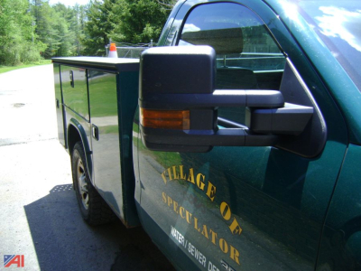 Truck side view showing utility bed with compartments on a Chevrolet Silverado 3500HD utility truck.