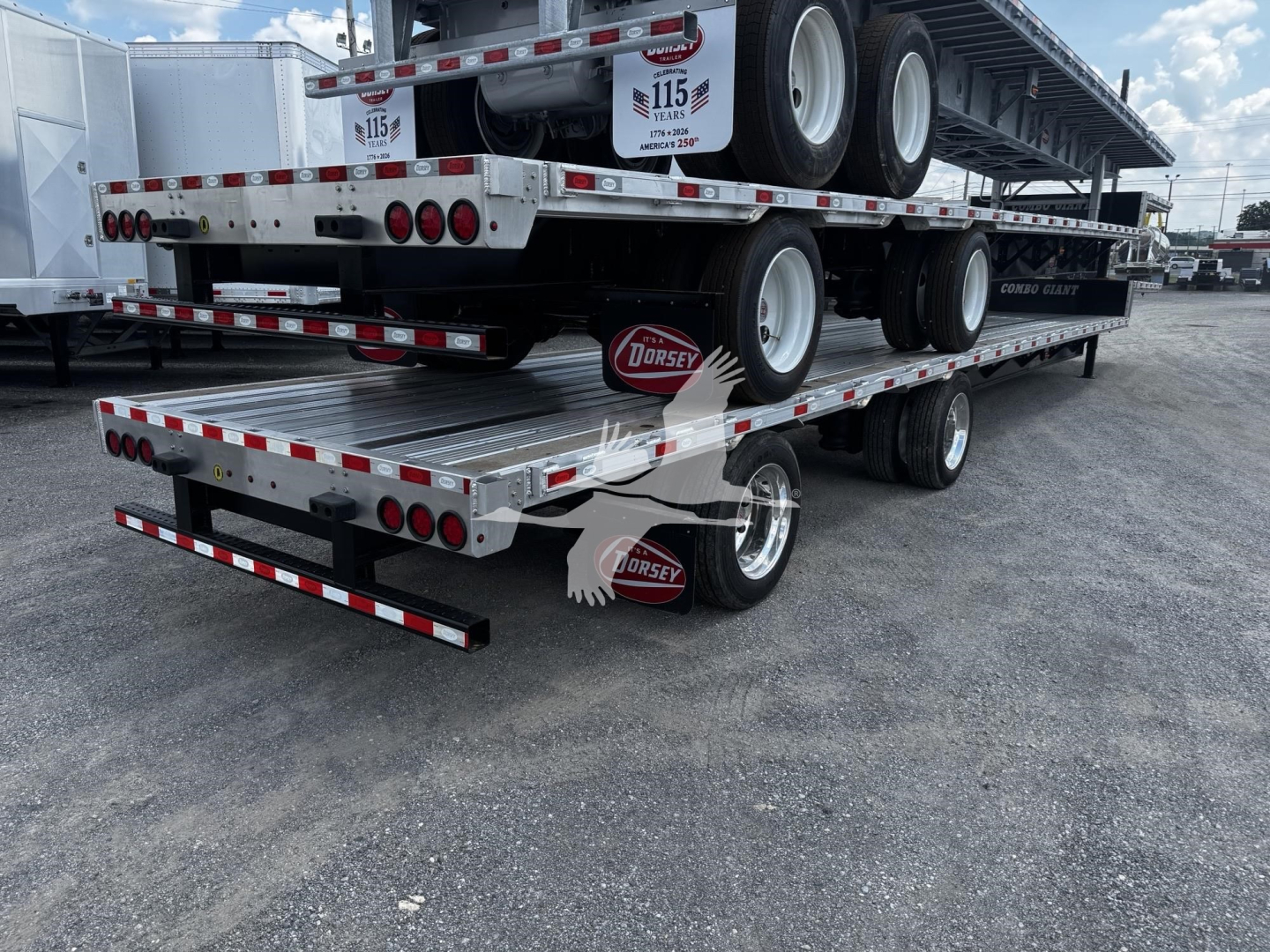 Trailer stack showing multiple flatbed trailers and wheels with Dorsey logo and safety markings.
