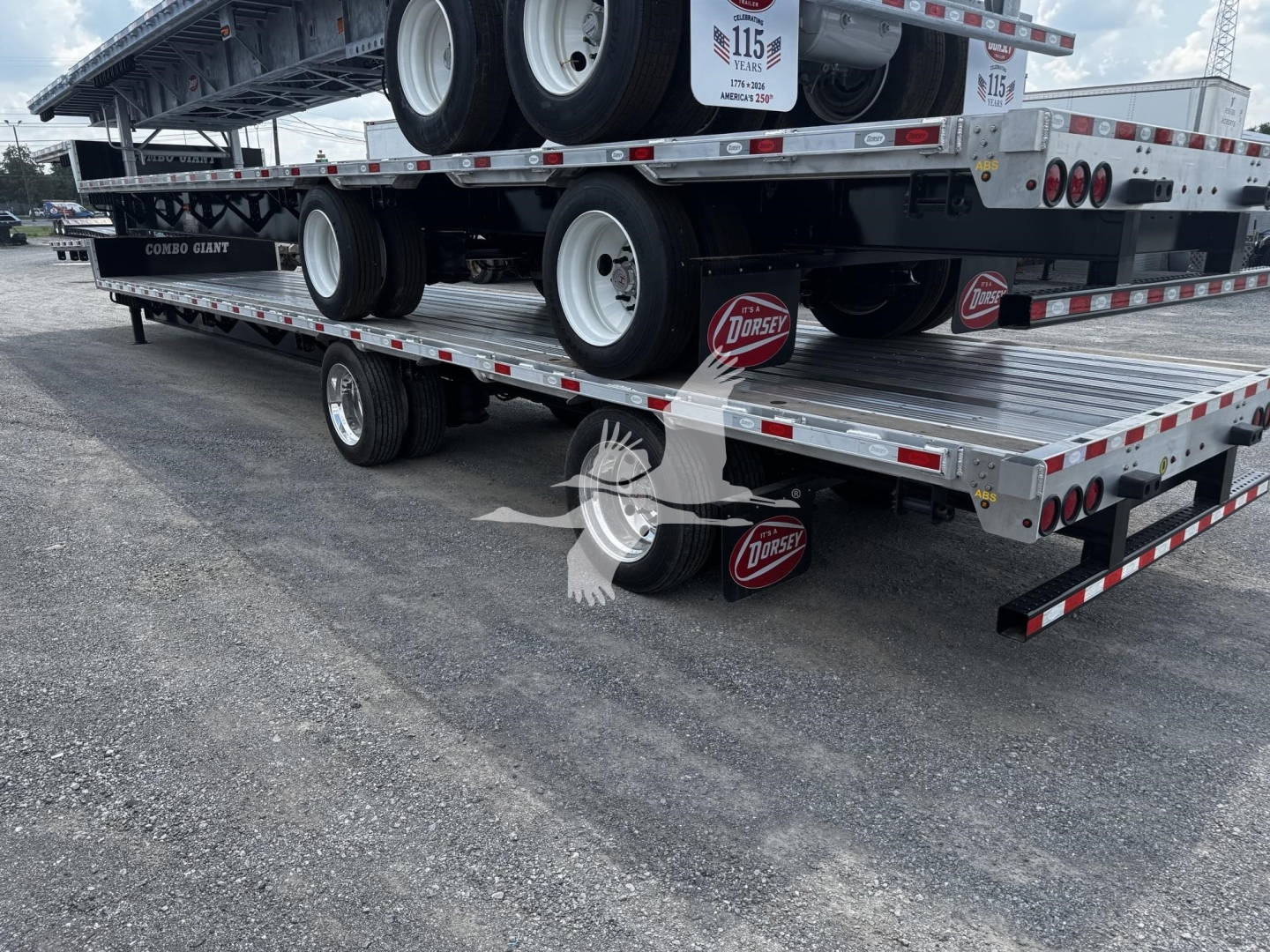 Flatbed trailer stack showing multiple decks and tires with Dorsey logo on red mud flaps and metal checker plates.