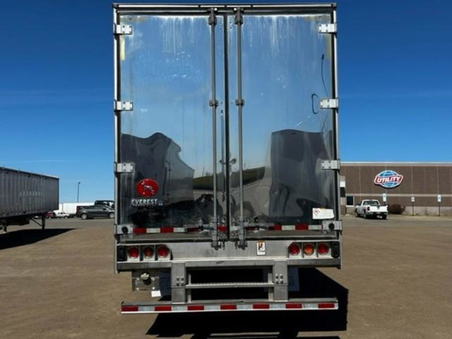 Rear view of a 2019 Great Dane reefer trailer with double doors, reflective surface, and rear bumper.