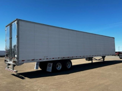 Great Dane refrigerated trailer in side view showing dual rear doors and triple-axle wheels.