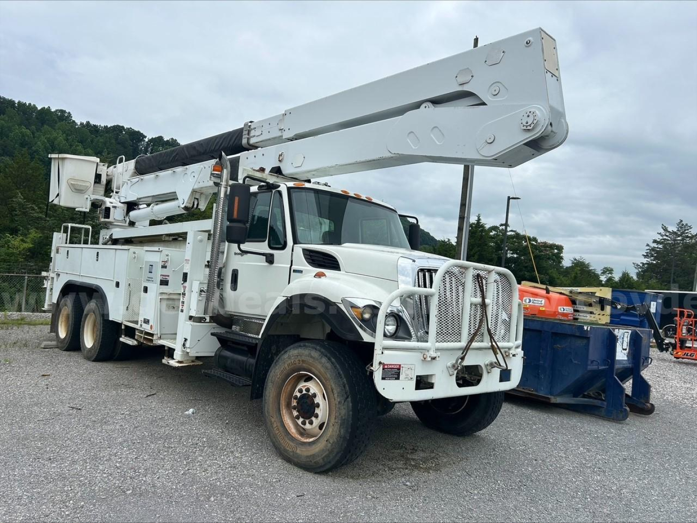 Integrated bucket truck on International chassis showing extended boom and utility body