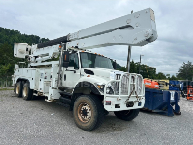 Integrated bucket truck on International chassis showing extended boom and utility body