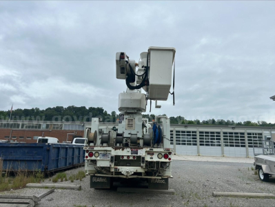 Bucket truck rear view showing articulated boom and hydraulic components on International 7500 chassis.