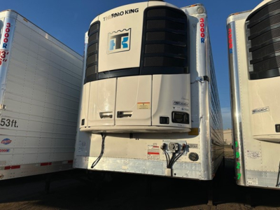 Reefer trailer front view with Thermo King unit mounted on front of white trailer doors and side skirts visible