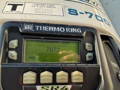 Thermo King S-700 Thermo King unit on a reefer trailer showing total engine run hours 7072 on the green display panel.