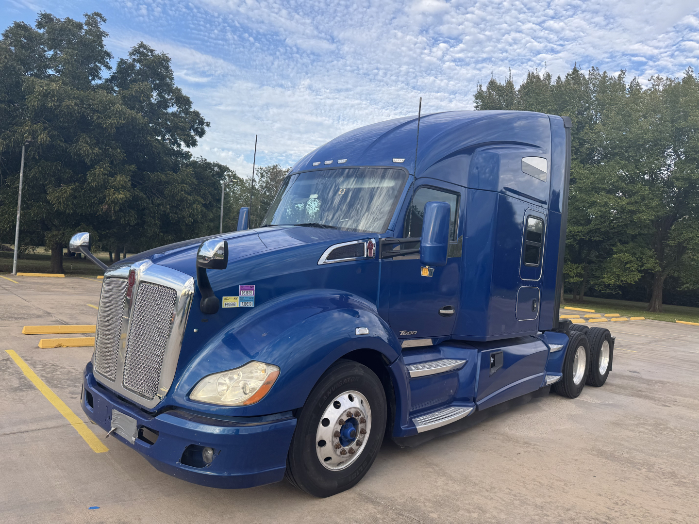 Peterbilt 579 conventional sleeper truck in blue, side view showing cab, aerodynamic hood, and dual rear axles.
