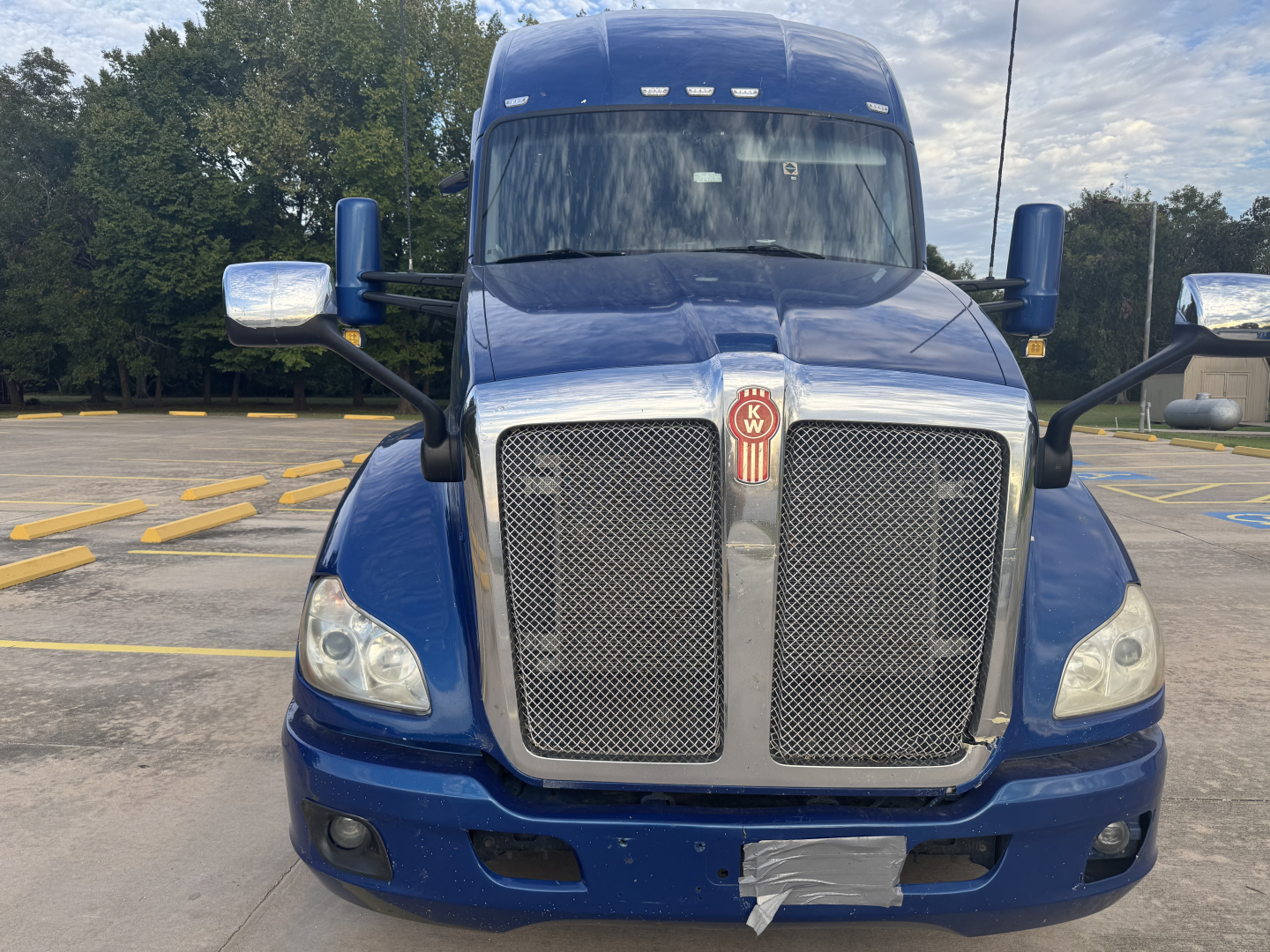 Peterbilt 579 conventional sleeper truck front view showing large chrome grille and blue paint.