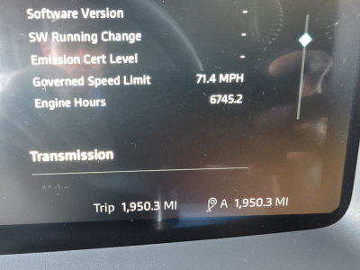 Truck instrument cluster display showing driving metrics: Governed Speed Limit 71.4 MPH, Engine Hours 6745.2, Trip 1,950.3 miles.