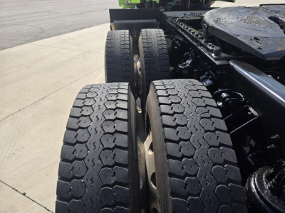 Dual rear wheels of a Kenworth T880 truck showing heavy-duty tire treads and rear axle assembly.