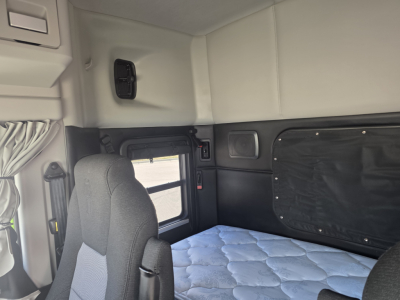 Kenworth T880 sleeper cab interior showing driver seat and quilted mattress in cabin